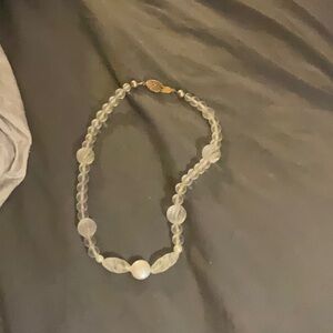 A clear necklace with pearls